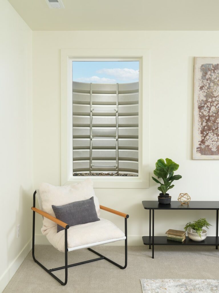 Light gray composite window well outside a basement window